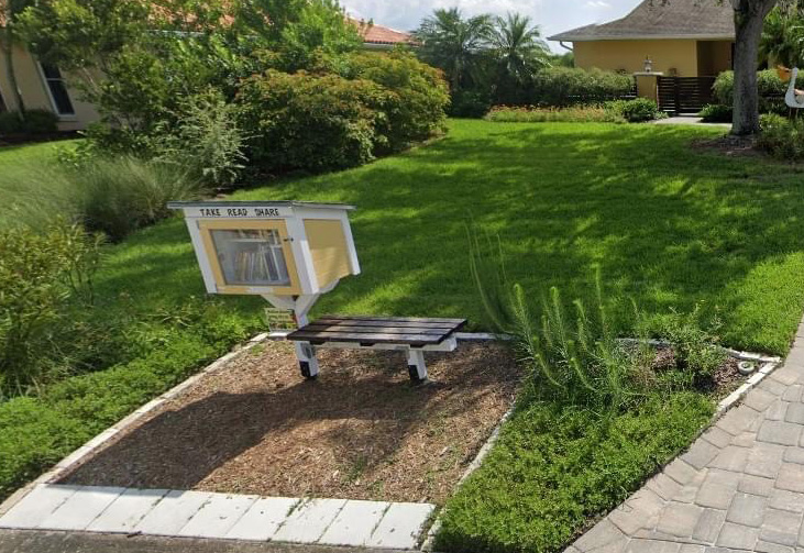 Little library with books, seeds, and plants