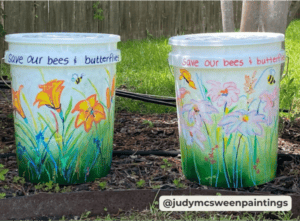 two mosquito buckets with wildlife painted on them